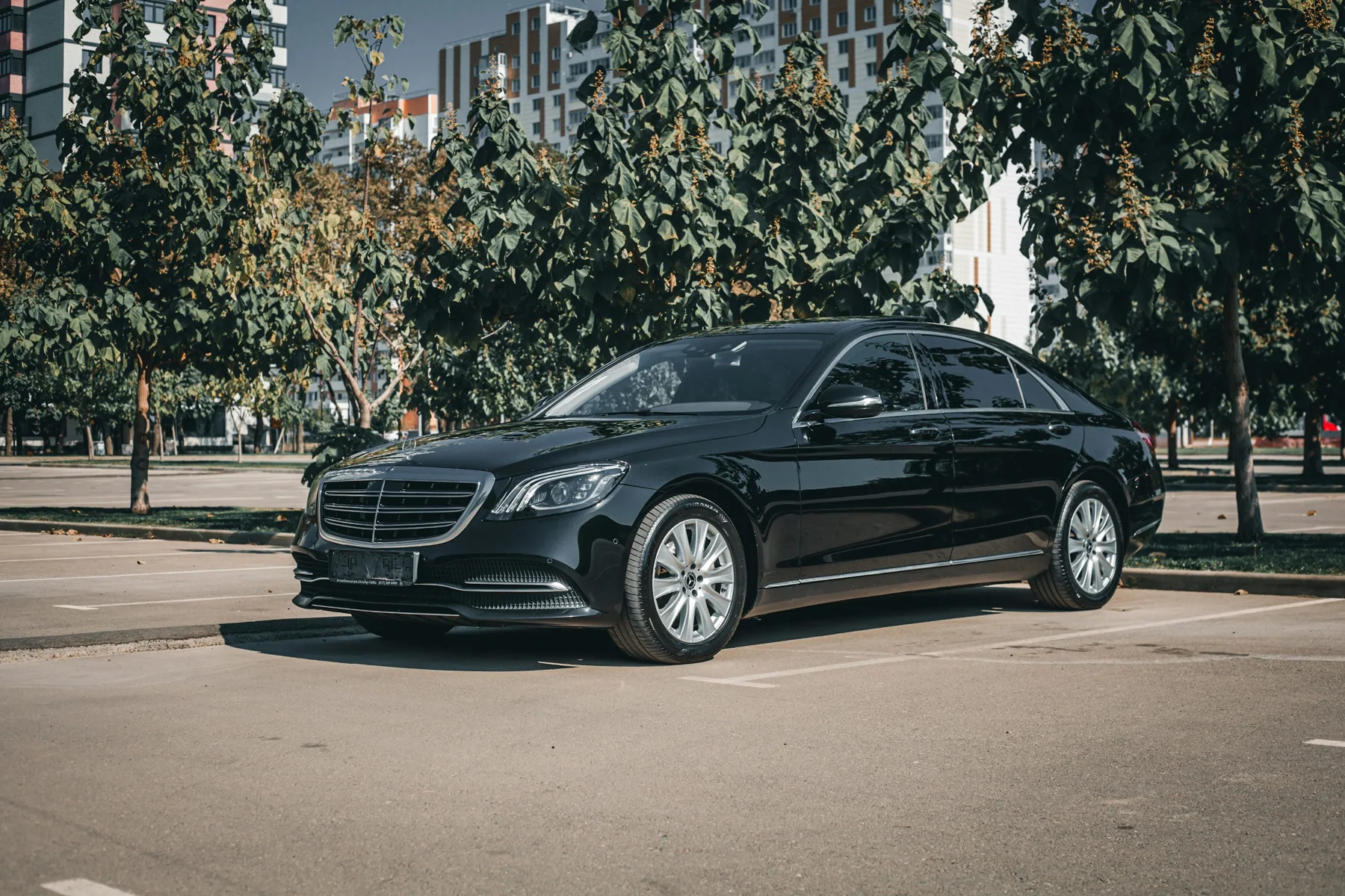 Illustrative executive car parked in an urban setting